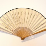 Writing on the Wall / Writing on Fans, live performance, writing with charcoal on an insignificant wall and on paper fans, 2012